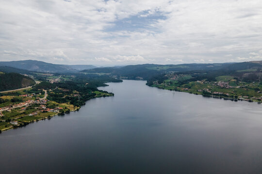 Aerial view of a small village along the Minho river in Val de Pereira, Ourense, Spain.