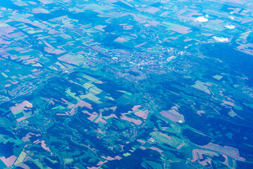 Fototapeta na wymiar View to a land and clouds from airplane