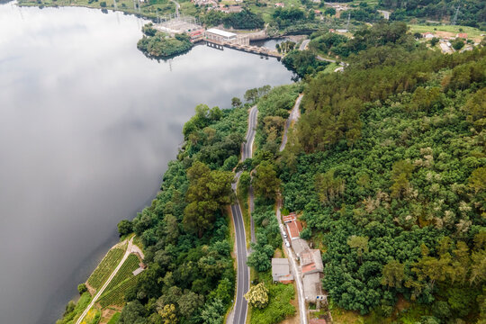 Aerial view of a road driving along the coast of Minho river in Val de Pereira, Ourense, Spain.