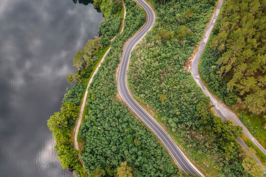 Aerial view of a road driving along the coast of Minho river in Val de Pereira, Ourense, Spain.