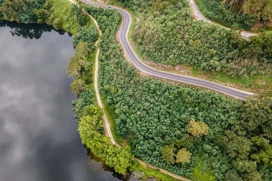 Aerial view of a road driving along the coast of Minho river in Val de Pereira, Ourense, Spain.