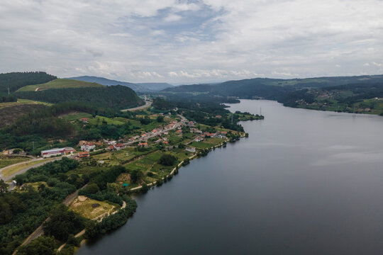 Aerial view of a small village along the Minho river in Val de Pereira, Ourense, Spain.