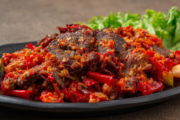 Jerado balado or Dendeng balado is a traditional cuisine from west sumatera, indonesia. it is made from slice of beef with spicy sauce called sambal.