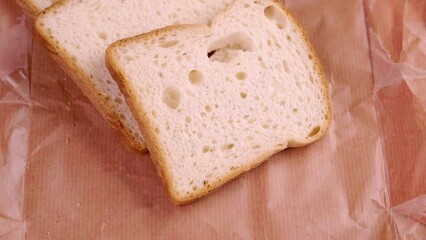 Sliced gluten free lactose free diet bread on wrapping paper closeup. Rotation