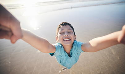 Person, spin kid and pov at beach, portrait and smile for game, excited and playing by water in sunshine. Parent, young boy child and swing with speed, love and bonding with holding hands by ocean - obrazy, fototapety, plakaty