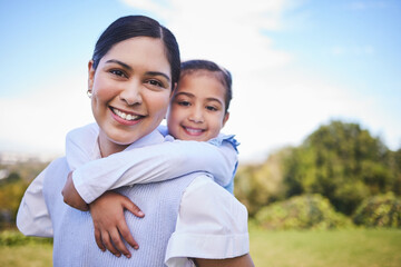 Obraz premium Happy mother, portrait and hug with child for quality time, bonding or love together in nature outdoors. Mom smile with daughter in piggyback enjoying summer weekend, holiday or vacation in the park