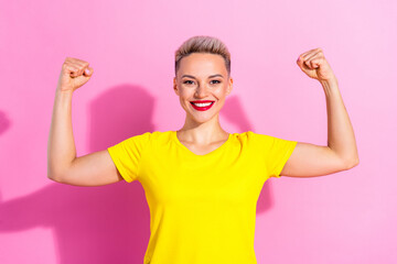Photo of gorgeous positive person toothy smile hands flexing demonstrate biceps muscle isolated on...