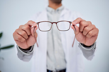 Hands, person and optometrist with glasses for vision, eyesight and prescription eye care. Closeup...