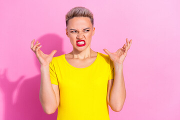 Photo of unsatisfied pretty lady grinning teeth raise arms fingers look empty space isolated on pink color background