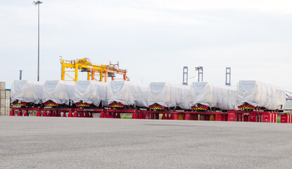 Transport of Oversize Heavy Machinery cargo truck Loading a new locomotive port area