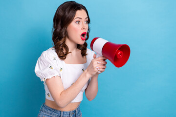 Photo portrait of lovely young lady hold loudspeaker screaming empty space wear trendy white...