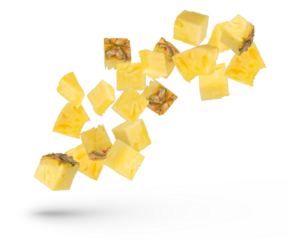 Pieces of pineapple on a white isolated background. Juicy pieces of pineapple with the remnants of the peel scatter in different directions. Isolate of flying pieces of pineapple.
