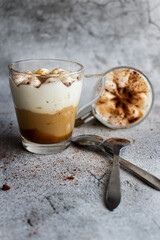 Coffee dessert. On a gray background.
Classic tiramisu in a cup