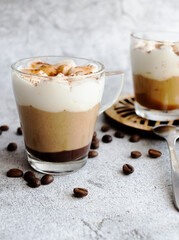 Coffee dessert. On a gray background.
Classic tiramisu in a cup