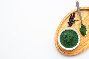 Dietary supplement for vegan Spirulina algae powder in bowl, top view