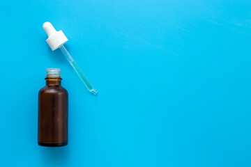 Face serum essential oil in dropper bottle top view