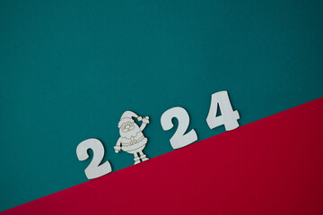 Happy New year 2024 number wood object on red and green background and copy space - new year...