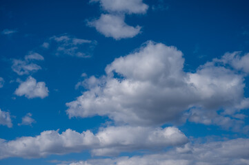 Fototapeta na wymiar Cumulus clouds against the blue sky on a summer day.