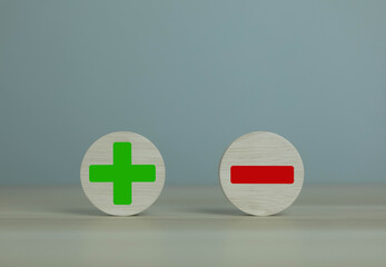 wooden blocks with plus and minus signs Comparatively opposite concepts Analyze differences to decide the positive or negative business options of the strategy.