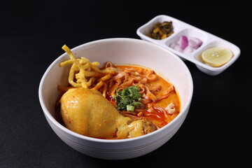 Khao Soi Thai Curry soup isolated in black background