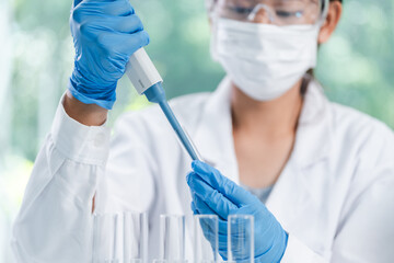 medicine research in chemical laboratory, chemist scientist working with liquid experiment test...