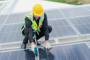 Professional specialist technician engineer working to maintenance checking and installing solar roof panel on the factory rooftop under sunlight. Worker inspection team for smart grid ecology energy