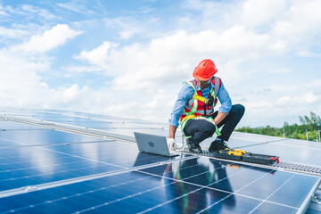 African American engineer maintaining solar cell panels on factory building rooftop. Technician working outdoor on ecological solar farm construction. Renewable clean energy technology concept © chokniti