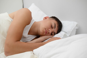 Obraz na płótnie Canvas Young Man Sleeping in Bed