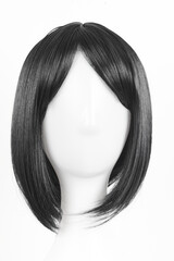 Natural looking black wig on white mannequin head. Medium length straight hair with bangs on the...