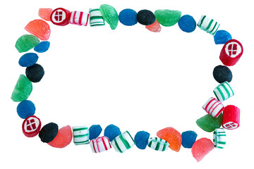 Frame of hard candy drops spread out on a white background, with copy space in the middle. Overhead view