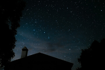 Shady house and night sky of stars