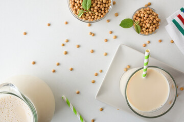 Background with soy alternative drink on white table top view