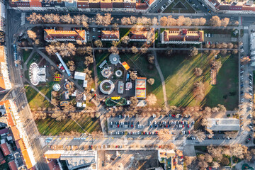 Aerial view of a theme park with Ferris wheel at Trg Franje Tudjmana park at sunset in Zagreb downtown, Croatia.