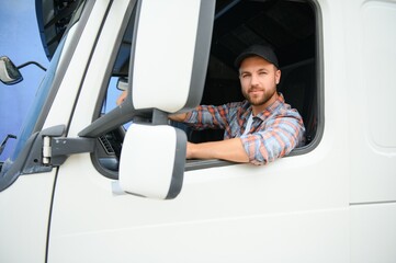 Side view of professional driver behind the wheel in truck's cabin. - Powered by Adobe