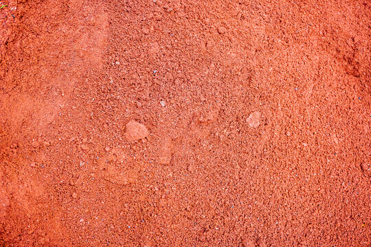 Dry red crushed bricks dust surface. Crushed red brick as a texture background of natural materials