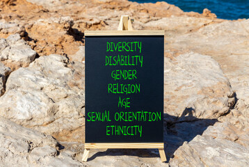 Diversity ethnicity gender age sexual orientation religion disability words written on black chalk...
