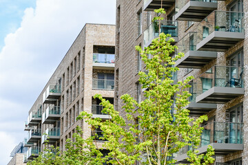 London, UK, 11 July 2023: Modern apartment building with balconies and blue sky at Green Street development in London
