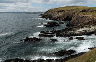 Rocky coastal area with windy  dangerous waves crashing on the rocks.