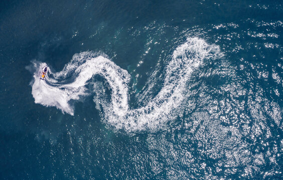 Aerial view of a water bike forming a white snake like trail in the water, Acre, Northern District, Israel.