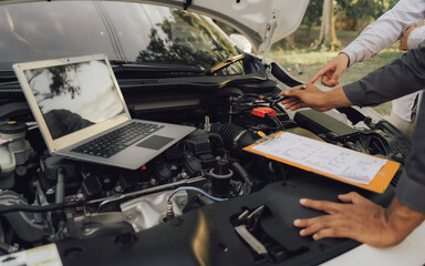 Man inspecting and servicing the engine, bonnet, safety test tool before the customer is on a long trip	