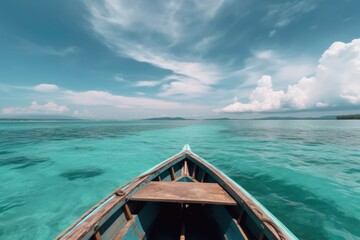 Obraz premium Boat in turquoise ocean water against blue sky with white clouds and tropical island. Ai generative.