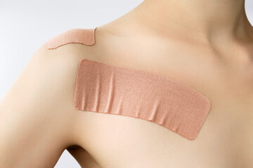 medical taping scheme for posture. beige medical stretch tape on the female chest muscles (relaxing...