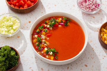 Spanish tomato gazpacho cold soup styled and decorated in white plate