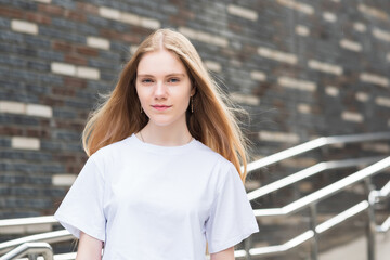 portrait of young woman against a blurred urban background