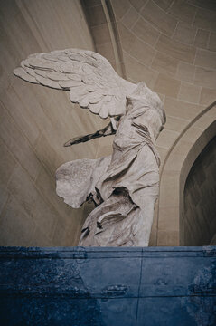 PARIS, FRANCE - July 08, 2023: Winged Victory of Samothrace, called Nike of Samothrace, marble sculpture in Louvre Museum