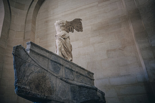 PARIS, FRANCE - July 08, 2023: Winged Victory of Samothrace, called Nike of Samothrace, marble sculpture in Louvre Museum