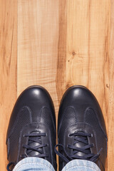 Comfortable navy blue leather shoes on rustic board, male footwear, place for text