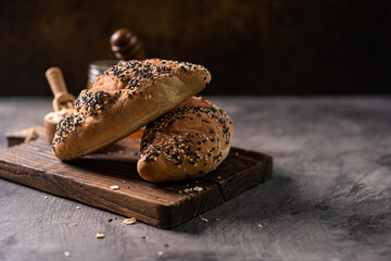 Fresh homemade bread whole wheat baguette on napkin and abstract table. Sourdough bread

