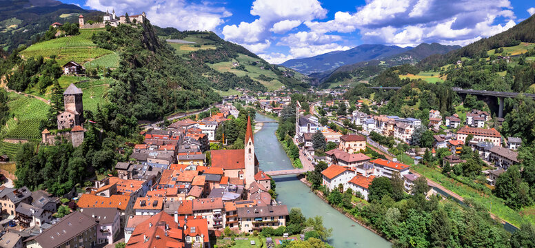 Scenic beautiful places of northern Italy. Charming village Chiusa surrounded by Dolomites mountains. panoramic arerial view.  South Tyrol, Bolzano province