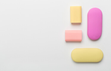 Colorful erasers on color backgroung, top view